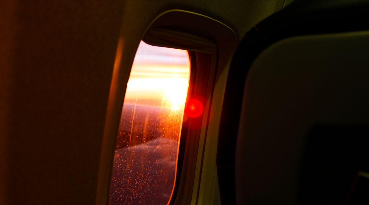 View of clouds and a wing from an airplane window seat