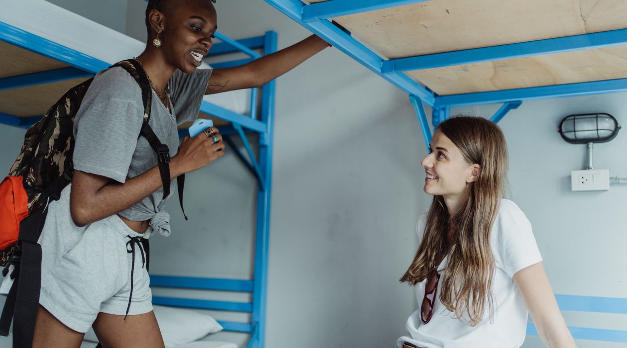 Backpackers relaxing in a bright hostel common area