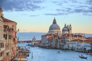 Grand Canal in Venice at sunset with gondolas and historic palazzos, North Italy
