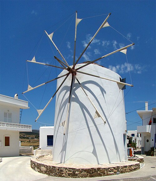 Whitewashed street with flowers on Paros island, Cyclades Greece